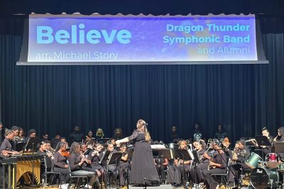Ellie Campbell conducts a high school band.